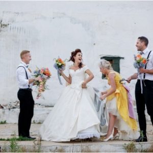 Bestmen And Maid Of Honour Assisting Fairytale Bride