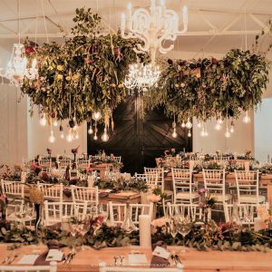 Wedding Decor Greenery And Flowers Hanging From Ceilings With Lighting