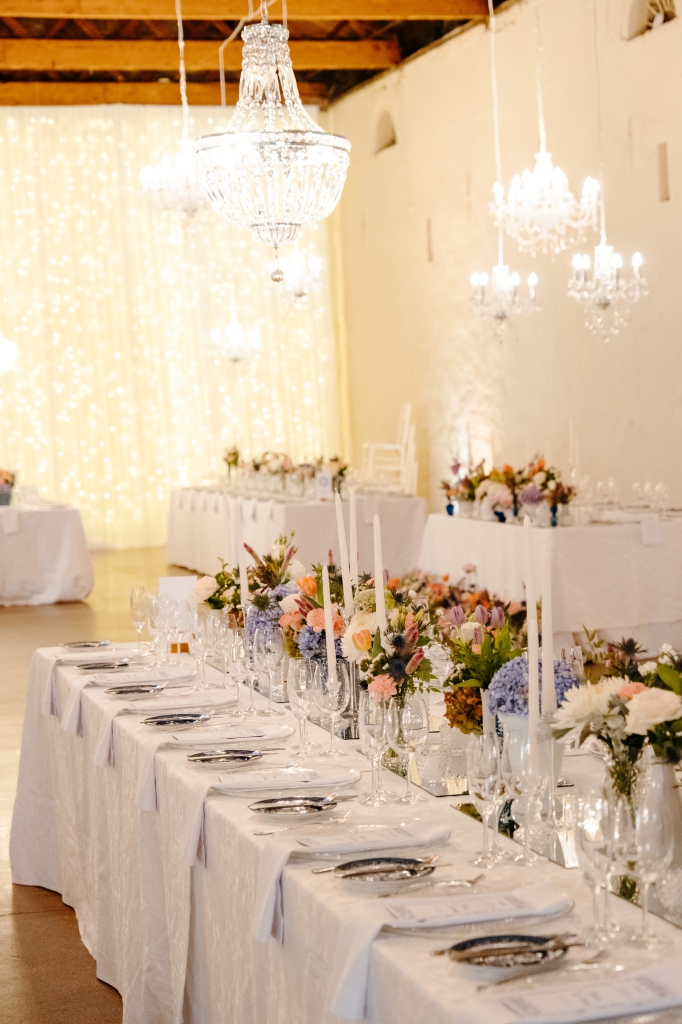 My Pretty Vintage Wedding Décor and Floral Stylist & Wedding Hire. Guest Table with Chrystal Chandeliers, White and Blue Delft Dinnerware with Colourful Flowers